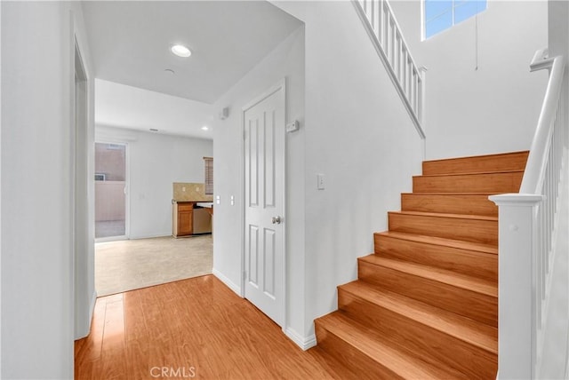 4564 Vincent Way, Riverside, CA 92501 - staircase with wood finished floors, plenty of natural light, and recessed lighting