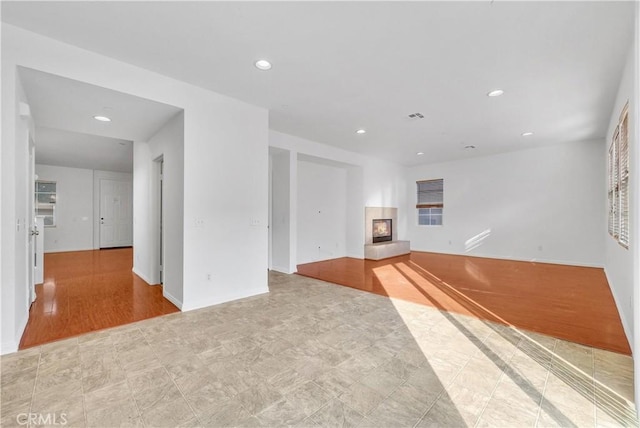 4564 Vincent Way, Riverside, CA 92501 - unfurnished living room featuring a glass covered fireplace and recessed lighting