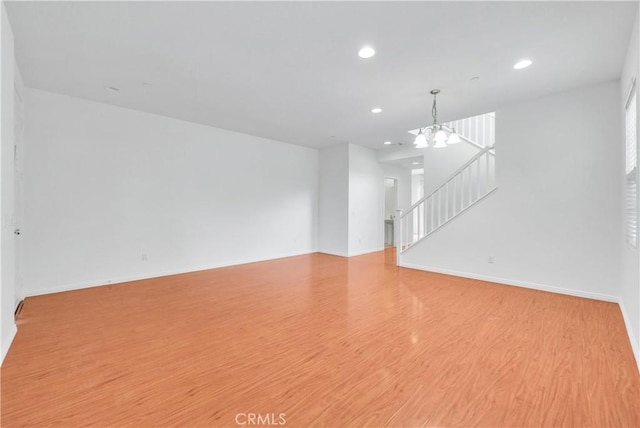 4564 Vincent Way, Riverside, CA 92501 - unfurnished living room featuring recessed lighting, wood finished floors, a chandelier, and stairway