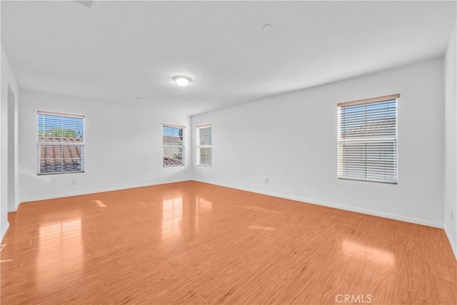 4564 Vincent Way, Riverside, CA 92501 - empty room featuring healthy amount of natural light and wood finished floors