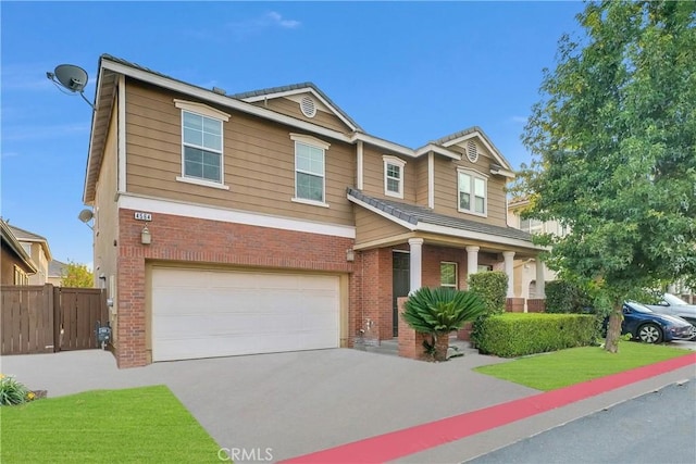 4564 Vincent Way, Riverside, CA 92501 - view of front of property with brick siding, a garage, driveway, and covered porch