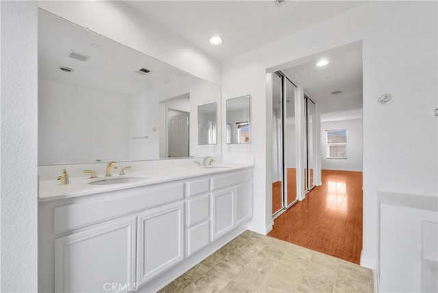 4564 Vincent Way, Riverside, CA 92501 - bathroom featuring double vanity and recessed lighting