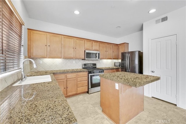 4564 Vincent Way, Riverside, CA 92501 - kitchen featuring stainless steel appliances, a kitchen island, light stone countertops, tasteful backsplash, and recessed lighting