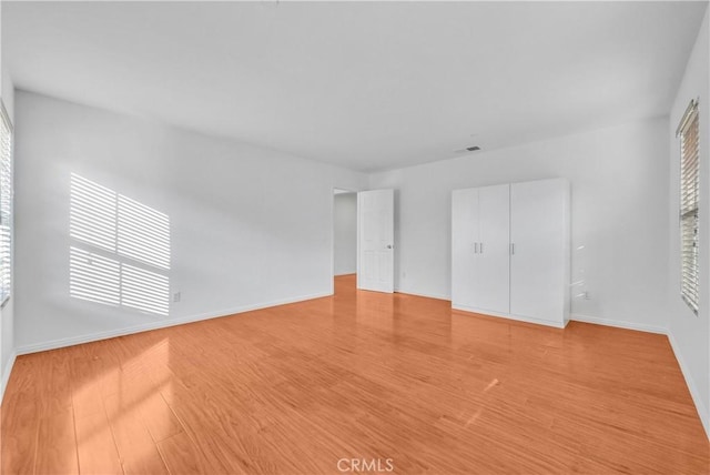 4564 Vincent Way, Riverside, CA 92501 - unfurnished bedroom with light wood finished floors and baseboards
