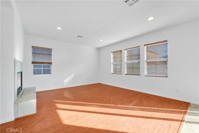 4564 Vincent Way, Riverside, CA 92501 - unfurnished room featuring a warm lit fireplace, recessed lighting, and wood finished floors