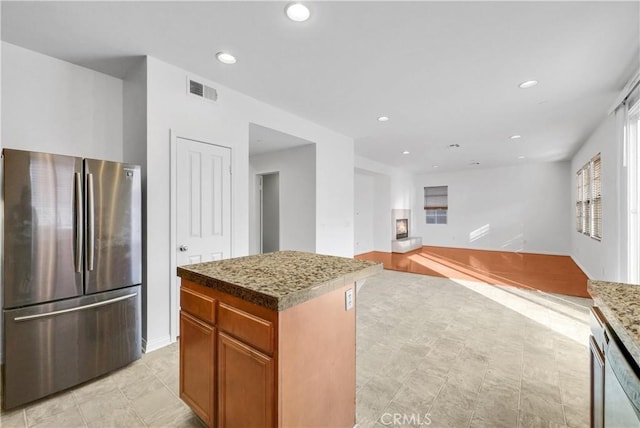 4564 Vincent Way, Riverside, CA 92501 - kitchen featuring freestanding refrigerator, dishwashing machine, recessed lighting, a center island, and brown cabinetry
