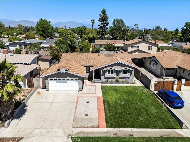 9712 Saloma Ave, North Hills, CA 91343 - view of front facade featuring driveway, a residential view, an attached garage, and a mountain view