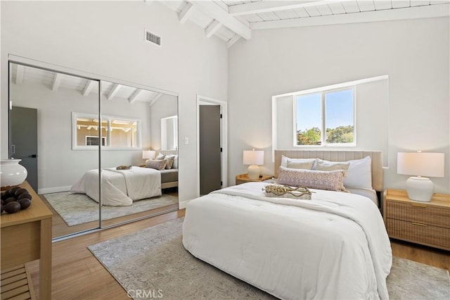9712 Saloma Ave, North Hills, CA 91343 - bedroom with wood finished floors, multiple windows, a closet, high vaulted ceiling, and a wooden ceiling with exposed beams