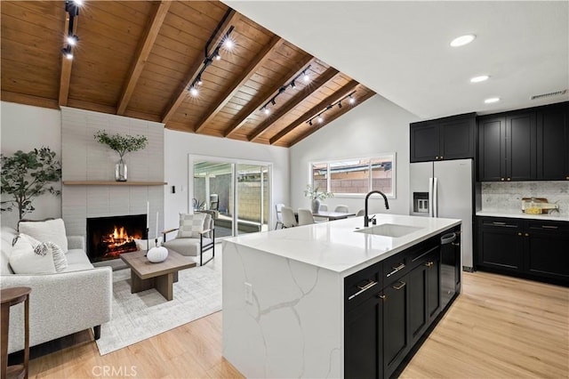 9712 Saloma Ave, North Hills, CA 91343 - kitchen featuring a wooden ceiling with exposed beams, track lighting, dark cabinets, open floor plan, and light wood-style floors