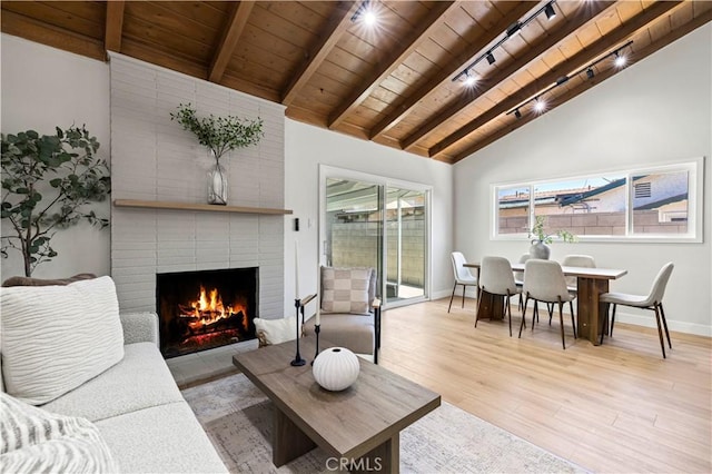 9712 Saloma Ave, North Hills, CA 91343 - living area featuring a wood ceiling with exposed beams, light wood-style floors, a fireplace, rail lighting, and high vaulted ceiling