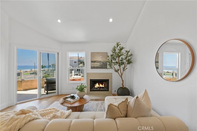 2000 Pacific Coast Hwy Unit 313, Huntington Beach, CA 92649 - living room featuring lofted ceiling, wood finished floors, recessed lighting, and a tile fireplace