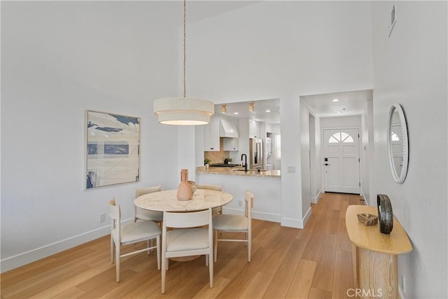 2000 Pacific Coast Hwy Unit 313, Huntington Beach, CA 92649 - dining room featuring light wood-style floors, a high ceiling, and recessed lighting