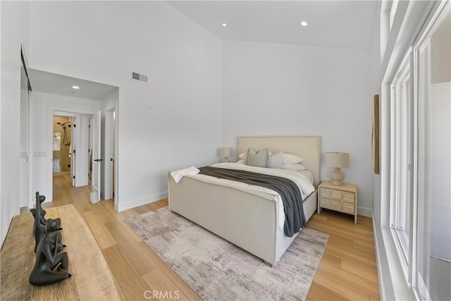 2000 Pacific Coast Hwy Unit 313, Huntington Beach, CA 92649 - bedroom with a towering ceiling, light wood-style flooring, and recessed lighting