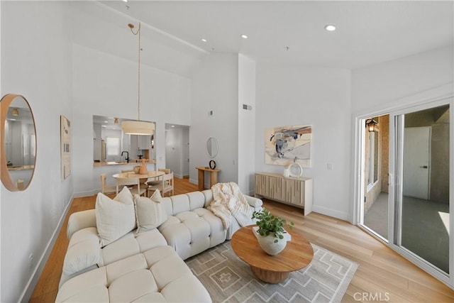 2000 Pacific Coast Hwy Unit 313, Huntington Beach, CA 92649 - living room featuring light wood-style flooring, high vaulted ceiling, and recessed lighting