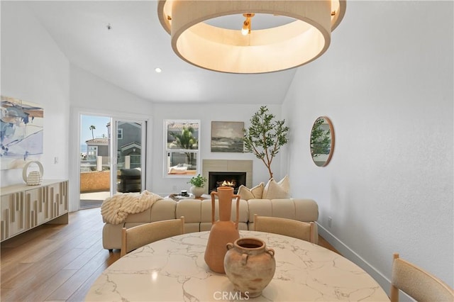 2000 Pacific Coast Hwy Unit 313, Huntington Beach, CA 92649 - living area with lofted ceiling, light wood-style flooring, a lit fireplace, and recessed lighting