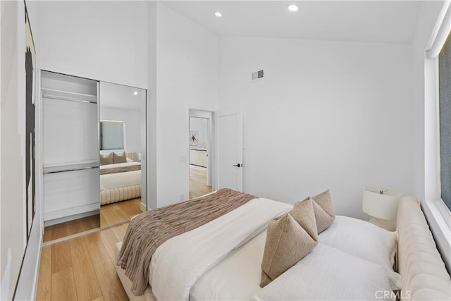 2000 Pacific Coast Hwy Unit 313, Huntington Beach, CA 92649 - bedroom featuring light wood finished floors, high vaulted ceiling, recessed lighting, and a closet