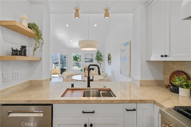 2000 Pacific Coast Hwy Unit 313, Huntington Beach, CA 92649 - kitchen with stainless steel dishwasher, open shelves, white cabinetry, and a peninsula