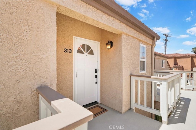 2000 Pacific Coast Hwy Unit 313, Huntington Beach, CA 92649 - doorway to property with stucco siding and a balcony