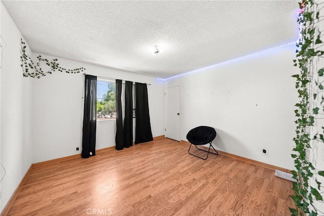 17162 Grand Ave, Lake Elsinore, CA 92530 - unfurnished room with a textured ceiling and light wood-style floors