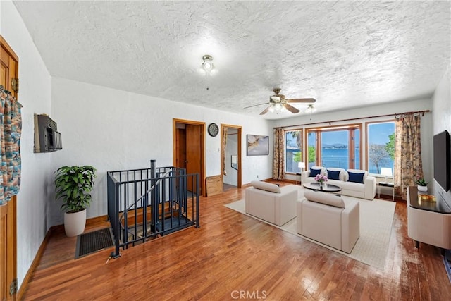 17162 Grand Ave, Lake Elsinore, CA 92530 - living area with a textured ceiling, wood finished floors, and a ceiling fan