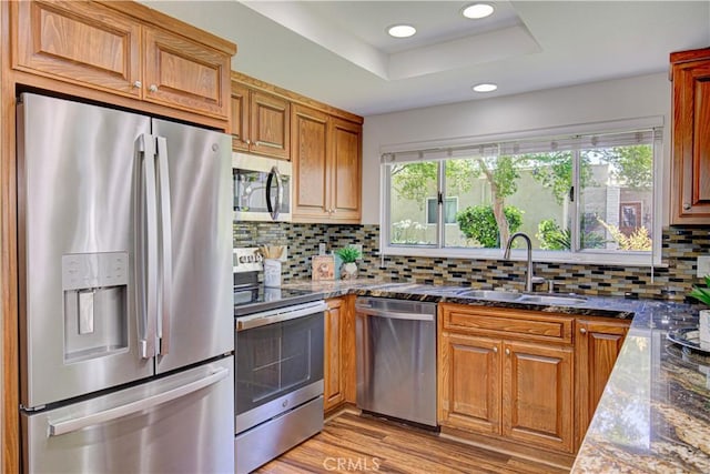 2164 Via Mariposa E Unit D, Laguna Woods, CA 92637 - kitchen featuring stainless steel appliances, plenty of natural light, decorative backsplash, recessed lighting, and brown cabinets