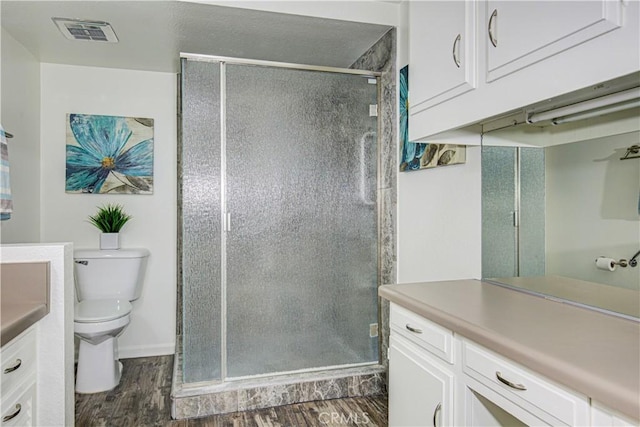 2164 Via Mariposa E Unit D, Laguna Woods, CA 92637 - bathroom featuring vanity, wood finished floors, and a stall shower