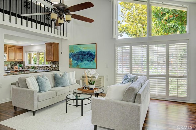 2164 Via Mariposa E Unit D, Laguna Woods, CA 92637 - living area featuring a ceiling fan, dark wood-style flooring, and a high ceiling
