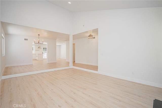 812 San Juan Ln, Placentia, CA 92870 - unfurnished living room featuring wood finished floors, a chandelier, and high vaulted ceiling