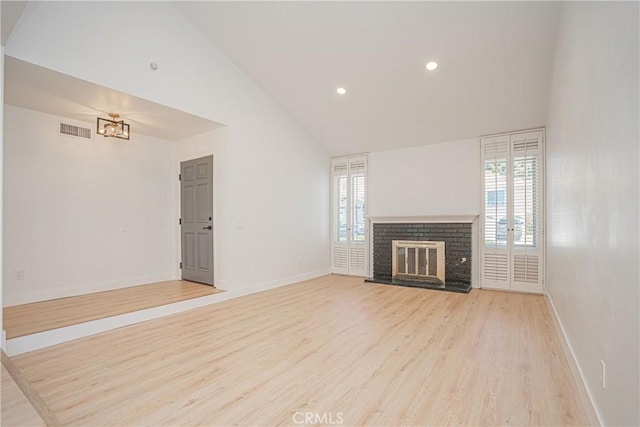812 San Juan Ln, Placentia, CA 92870 - unfurnished living room featuring light wood-type flooring, a brick fireplace, recessed lighting, and high vaulted ceiling