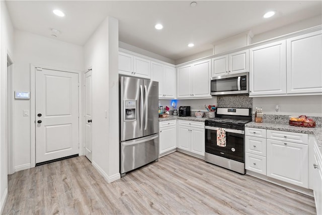 2848 E Berry Loop Privado Unit 52, Ontario, CA 91761 - kitchen featuring stainless steel appliances, white cabinetry, light wood-style flooring, light stone counters, and recessed lighting