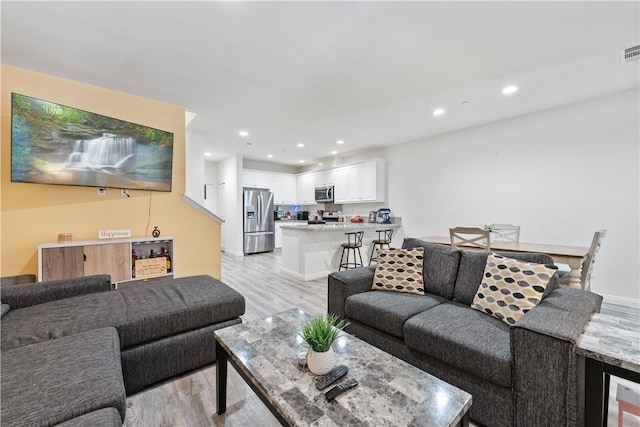 2848 E Berry Loop Privado Unit 52, Ontario, CA 91761 - living area with light wood-type flooring, recessed lighting, and wine cooler