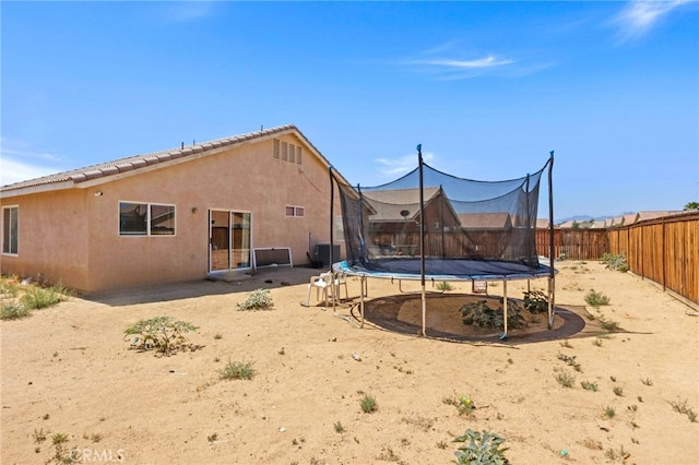 15460 Guava Way, Victorville, CA 92394 - fenced backyard featuring a trampoline