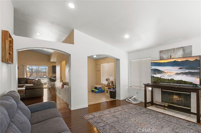 15460 Guava Way, Victorville, CA 92394 - living room with arched walkways, wood finished floors, recessed lighting, and a tile fireplace