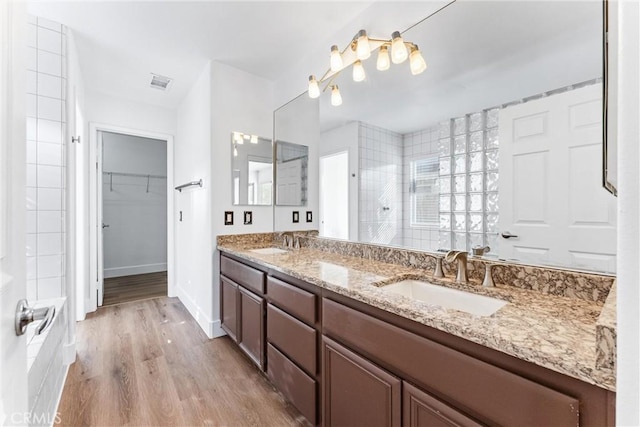 4441 Foxrun Dr, Chino Hills, CA 91709 - full bath featuring double vanity, tiled shower, wood finished floors, and a walk in closet