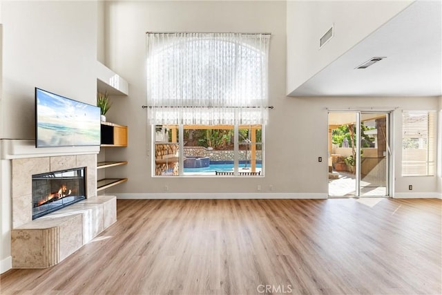 4441 Foxrun Dr, Chino Hills, CA 91709 - unfurnished living room with a high ceiling, wood finished floors, and a tiled fireplace