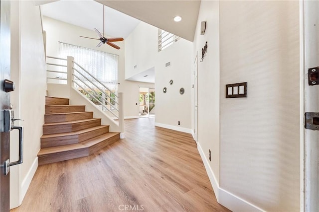 4441 Foxrun Dr, Chino Hills, CA 91709 - foyer entrance featuring ceiling fan, light wood-type flooring, stairway, and a high ceiling
