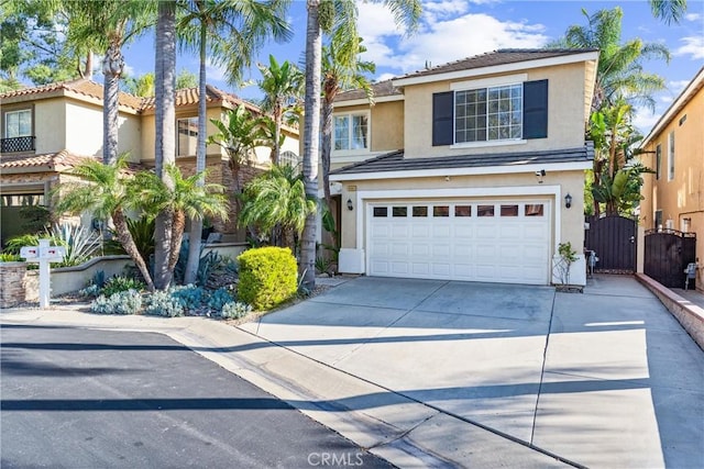 4441 Foxrun Dr, Chino Hills, CA 91709 - view of front of house featuring stucco siding, concrete driveway, a gate, an attached garage, and a tiled roof