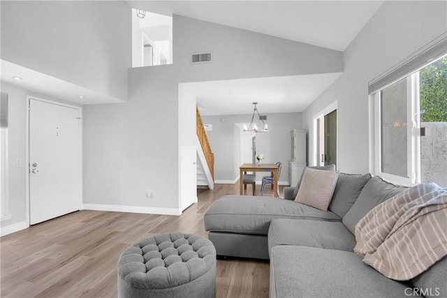373 N Via Remo, Anaheim, CA 92806 - living room with a chandelier, wood finished floors, high vaulted ceiling, and stairway