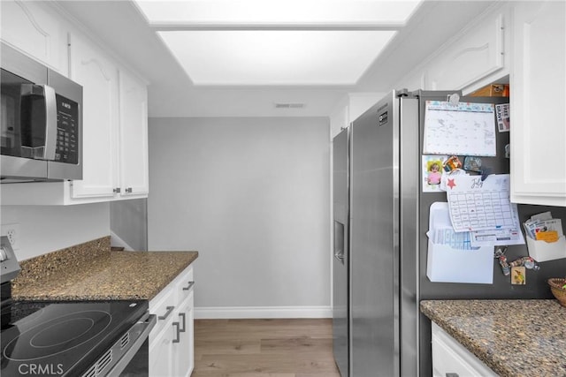 373 N Via Remo, Anaheim, CA 92806 - kitchen featuring appliances with stainless steel finishes, light wood-style flooring, white cabinetry, and dark stone counters
