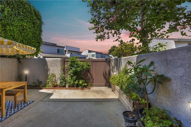 373 N Via Remo, Anaheim, CA 92806 - patio terrace at dusk with a patio area, a fenced backyard, and a gate