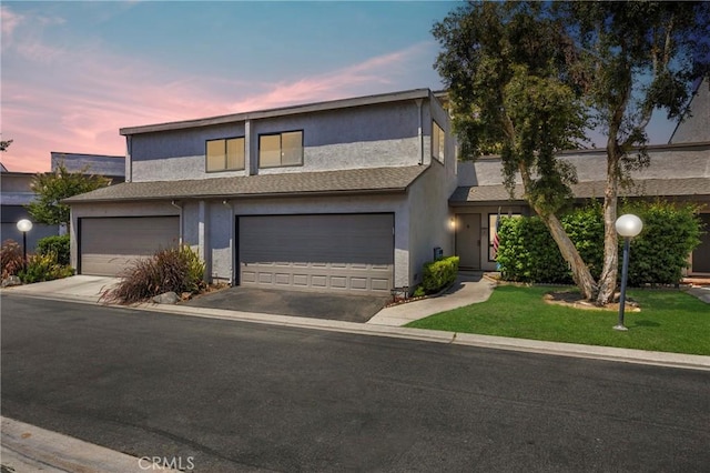 373 N Via Remo, Anaheim, CA 92806 - view of front of home featuring stucco siding, asphalt driveway, a lawn, and a garage