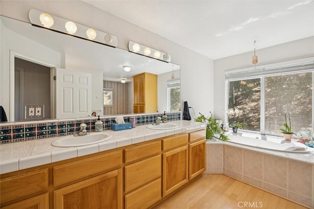9230 Las Lomas Ave, Atascadero, CA 93422 - full bathroom featuring wood finished floors, double vanity, and tiled bath