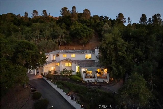 9230 Las Lomas Ave, Atascadero, CA 93422 - view of front of property featuring asphalt driveway, a tile roof, a view of trees, and stucco siding