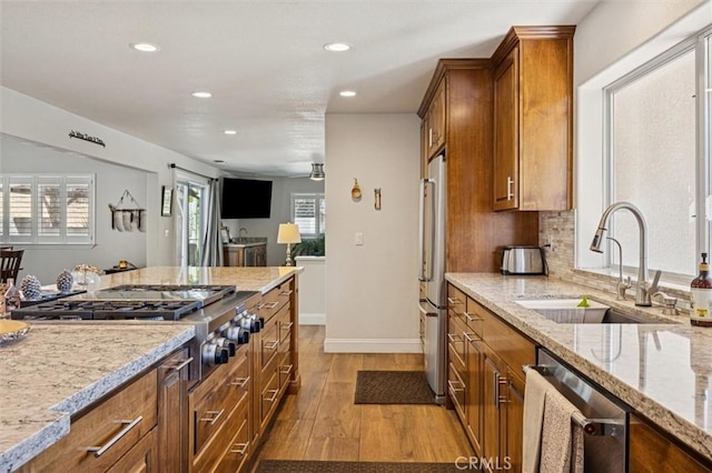 9230 Las Lomas Ave, Atascadero, CA 93422 - kitchen featuring appliances with stainless steel finishes, brown cabinets, wood finished floors, recessed lighting, and light stone countertops