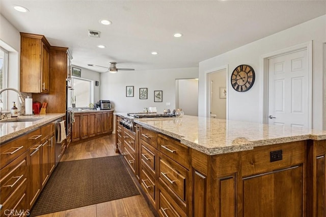 9230 Las Lomas Ave, Atascadero, CA 93422 - kitchen with stainless steel gas cooktop, dark wood-style flooring, plenty of natural light, recessed lighting, and light stone countertops