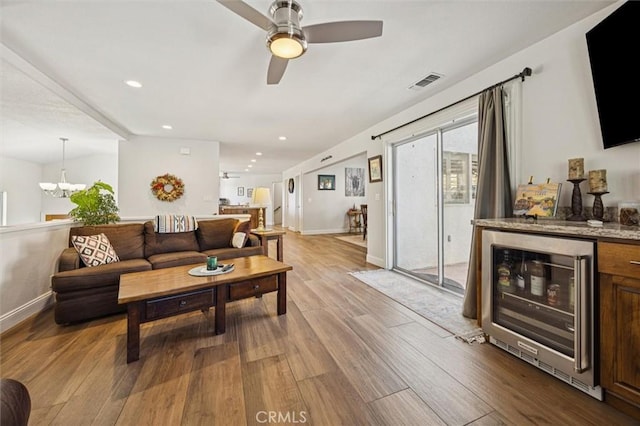 9230 Las Lomas Ave, Atascadero, CA 93422 - living room featuring wine cooler, wood finished floors, a ceiling fan, recessed lighting, and a chandelier