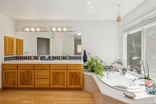 9230 Las Lomas Ave, Atascadero, CA 93422 - full bath featuring double vanity, wood finished floors, a whirlpool tub, and plenty of natural light