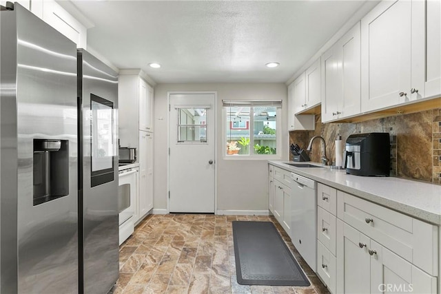 4783 Larwin Ave, Cypress, CA 90630 - kitchen with stainless steel fridge, white dishwasher, white cabinetry, tasteful backsplash, and recessed lighting