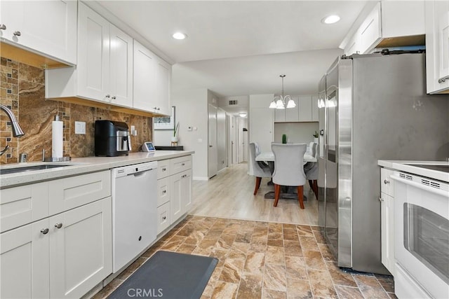 4783 Larwin Ave, Cypress, CA 90630 - kitchen with white appliances, a chandelier, white cabinetry, tasteful backsplash, and recessed lighting