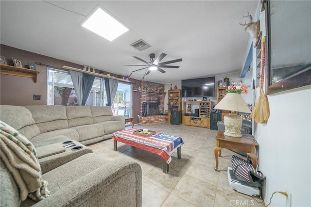 61497 Valley View Dr, Joshua Tree, CA 92252 - living room featuring a fireplace, ceiling fan, and light tile patterned floors